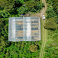 A large covered transparent drying room for freshly harvested coffee beans. 